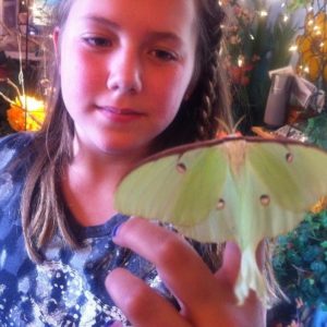 girl holding luna moth